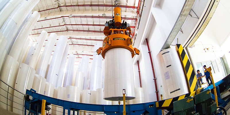 Paper Mill Production Scene with Crane Handling Paper Rolls